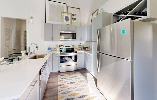 a kitchen with stainless steel appliances and white counter tops