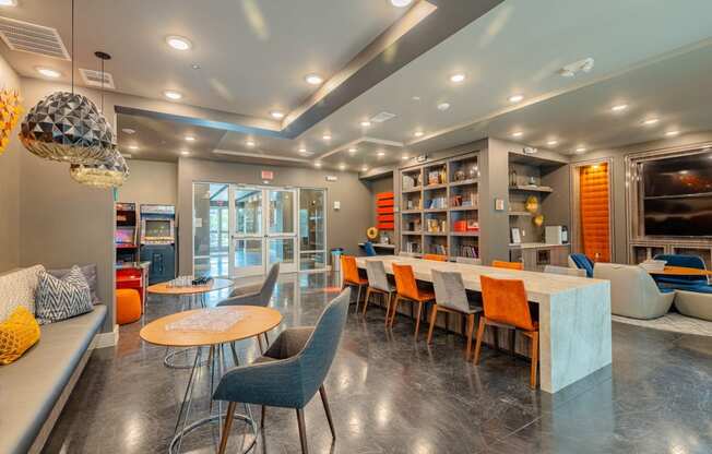 a living room with a long table and chairs