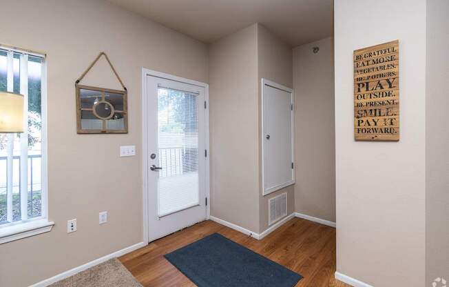 A room with a wooden floor and a sign on the wall.