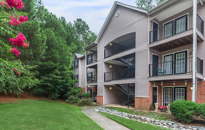 Lawn and apartment exteriors at Greens of Pine Glen in Durham NC