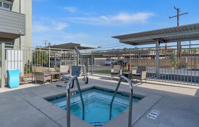 a pool with a fence around it at the whispering winds apartments in pearland, tx at Loma Villas Apartments, San Bernardino, 92408