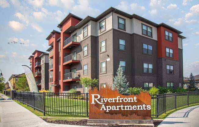 A modern apartment complex named Riverfront Apartments is shown.