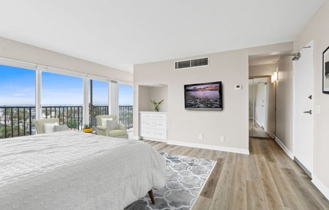 a bedroom with a large bed and a large window