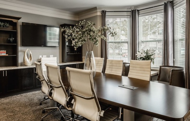 a dining room with a large table and chairs and a tv