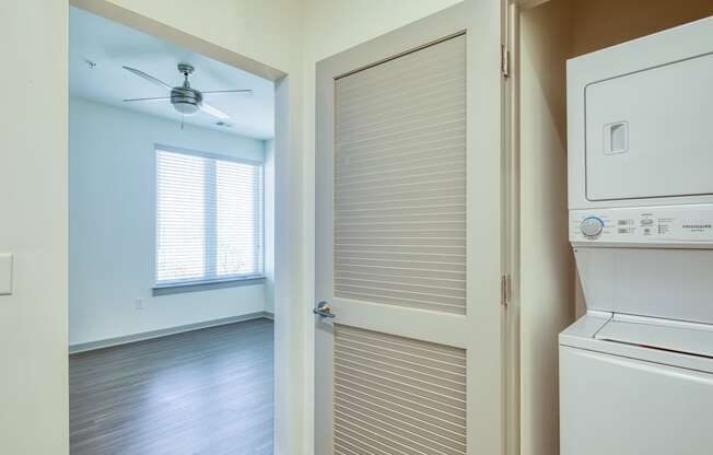 a laundry room with a washer and dryer and a closet with a door