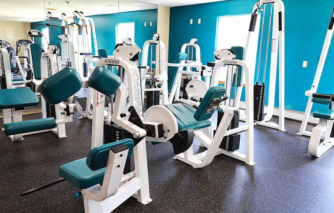 A gym with blue walls and a variety of equipment.