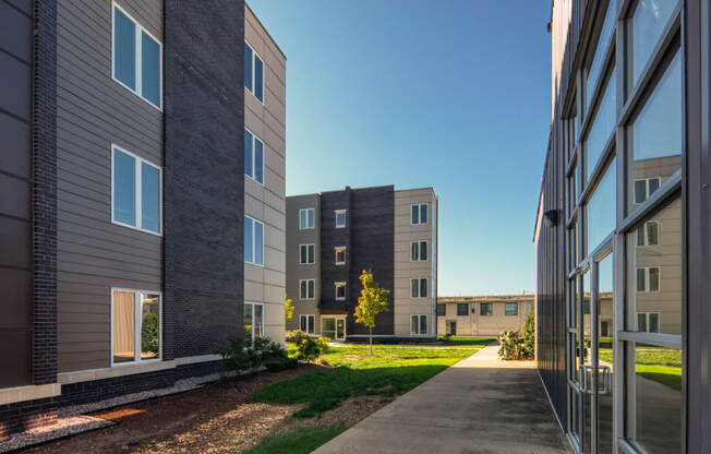 a view of an apartment building from a sidewalk