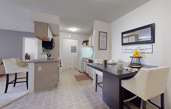 a kitchen and dining area with a table and chairs