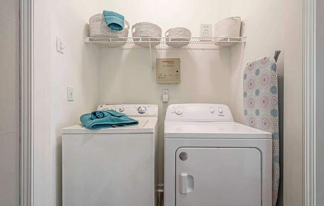 A white washing machine and dryer in a small laundry room.