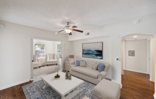 Living room with a couch and a coffee table and a ceiling fan | Via Lugano