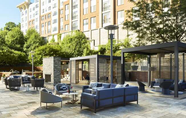 a rendering of a patio with couches and chairs at a hotel