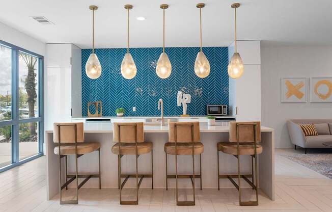 A kitchen with a blue backsplash and wooden bar stools.
