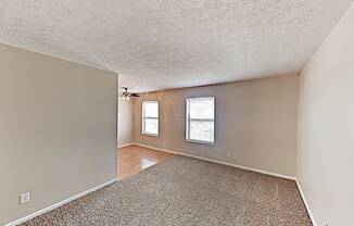 the living room and dining room of an empty house