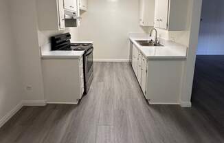 Kitchen with Hard Floors and White Cabinets