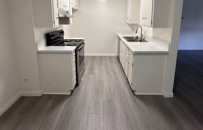 Kitchen with Hard Floors and White Cabinets