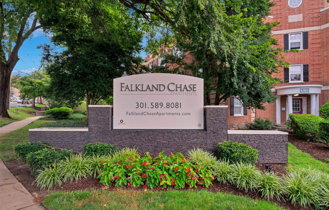 a sign for falkland chase in front of a brick building