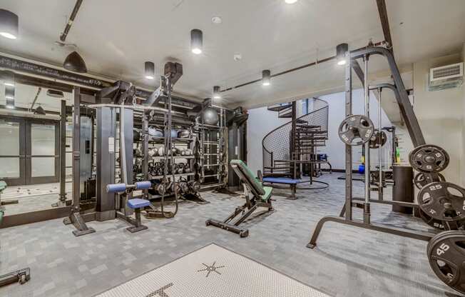 a gym with weights and other equipment in a building with