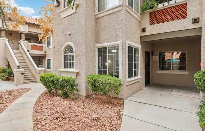 A house with a red brick pathway leading to the front door.