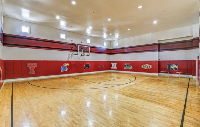 the gym is equipped with a basketball court and hardwood floors