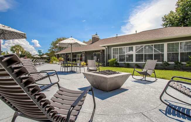 a large patio with chairs and umbrellas in front of the resident clubhouse at Reserve by the Lake, Houston, 77084