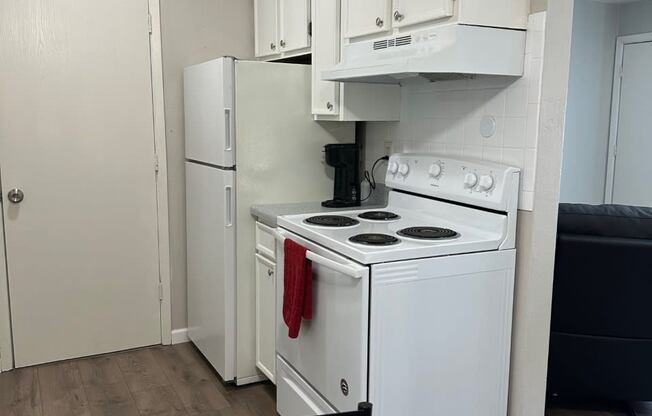 a kitchen with white appliances and a refrigerator and a stove at shiloh commons belleville