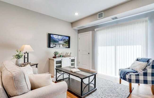 a living room with a couch and a chair. Circle Pines, MN Lexington Lofts