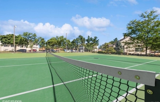 a tennis court with a net on it at apartment community