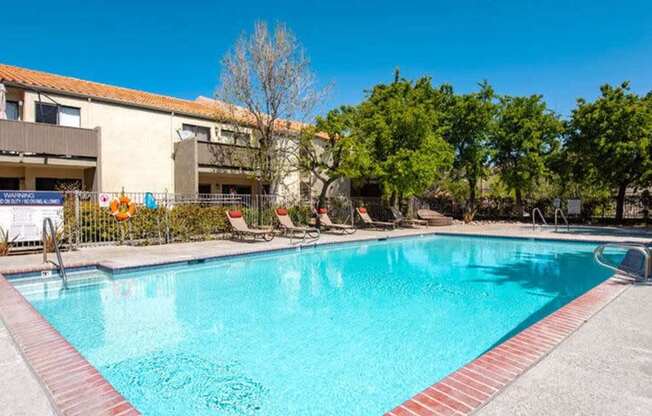 A swimming pool with a red brick border.