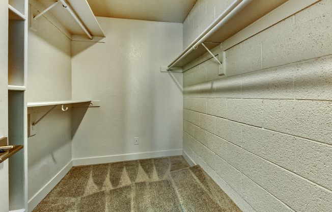 A small, empty room with a carpeted floor and white walls.