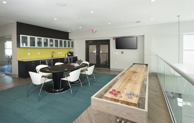 Game room with shuffleboard and poker table