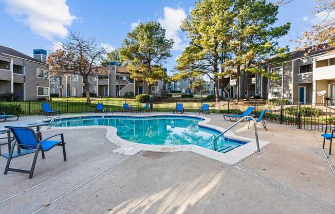 the preserve at ballantyne commons pool with blue chairs and apartment buildings