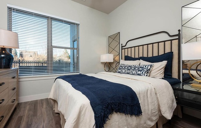 a bedroom with a bed and a large window