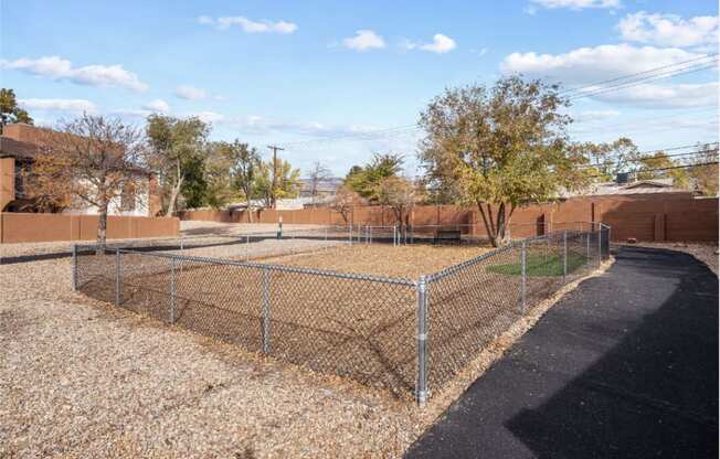 a fenced in dog park with a chain link fence
