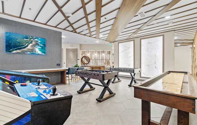 A room with a pool table and a ping pong table.