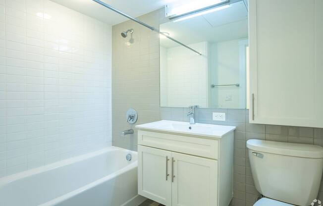 A white bathroom with a tub, sink, and toilet at 603 Concord Apartments, Cambridge 02138