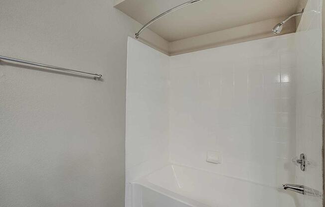 A white bathroom with a shower and a white tub at Sterling Point Apartment Homes, Arizona, 85042