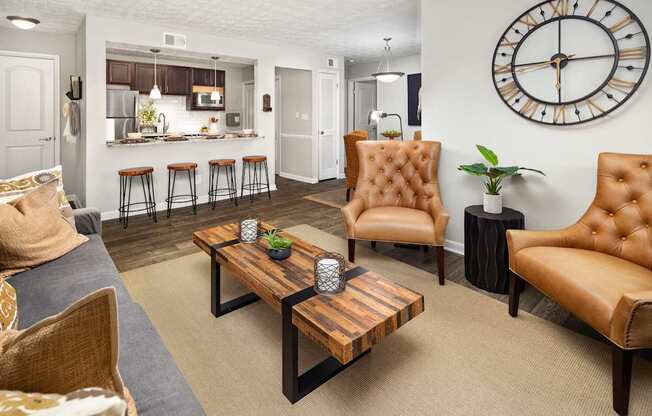 A living room with a brown leather chair and a wooden coffee table.