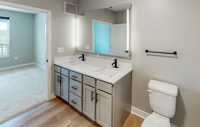 a bathroom with a toilet sink and mirror