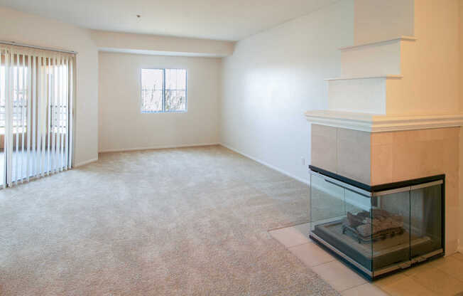 Carpeted Living Room with Gas Fireplace and Balcony
