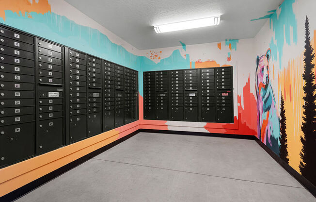 a locker room with a wall mural of mountains and trees