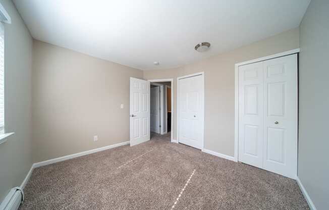 Bedroom with carpet and closet doors