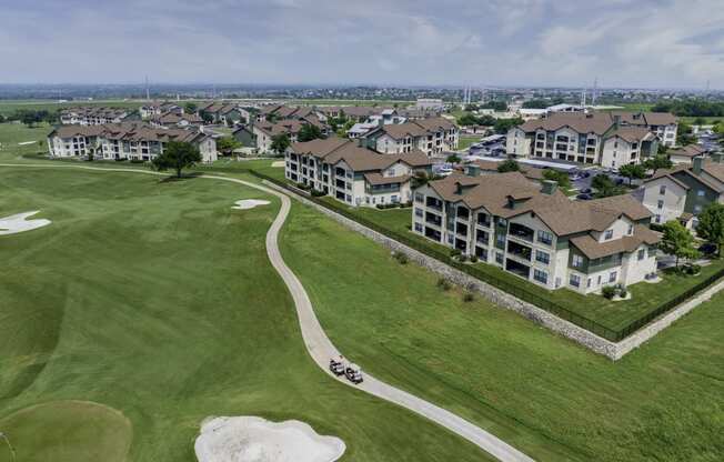 an aerial view of a neighborhood with houses and a golf course