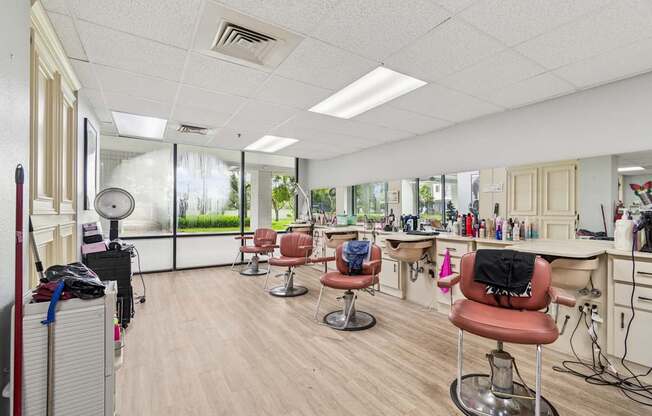 A hair salon with chairs and hairdressing stations at Hampton Apartments, Clearwater