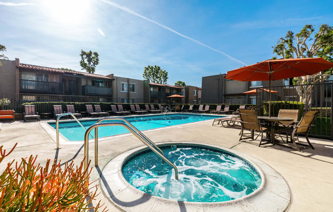 our apartments have a resort style pool with chairs and umbrellas