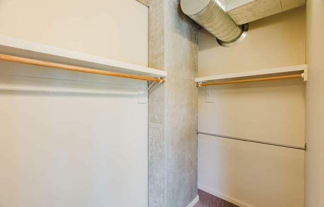 A white wall with a pipe running down it.