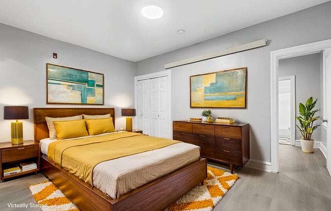 A bedroom with a large bed and two nightstands.