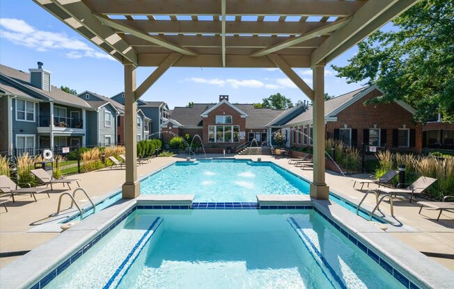 A large swimming pool under a wooden pergola. at Somerset Oaks Apartment Homes, Olathe 66062