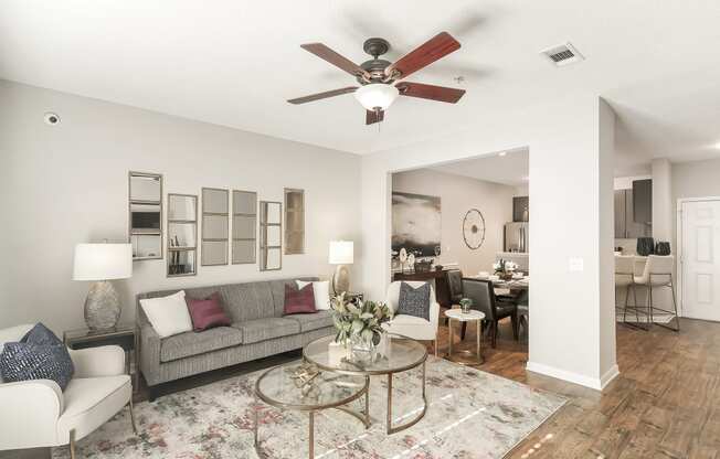 a living room with a ceiling fan and a couch at Lagniappe of Biloxi Apartment Homes, Biloxi, MS
