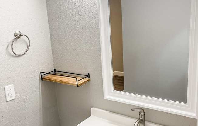 a small bathroom with a sink and a mirror