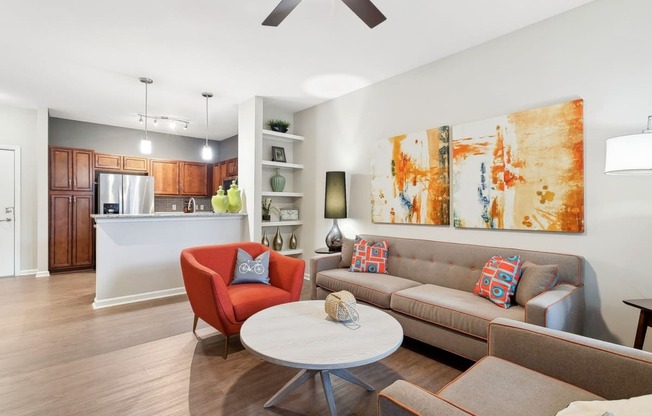 spacious kitchen and living room with wood-inspired flooring at Sorelle apartments